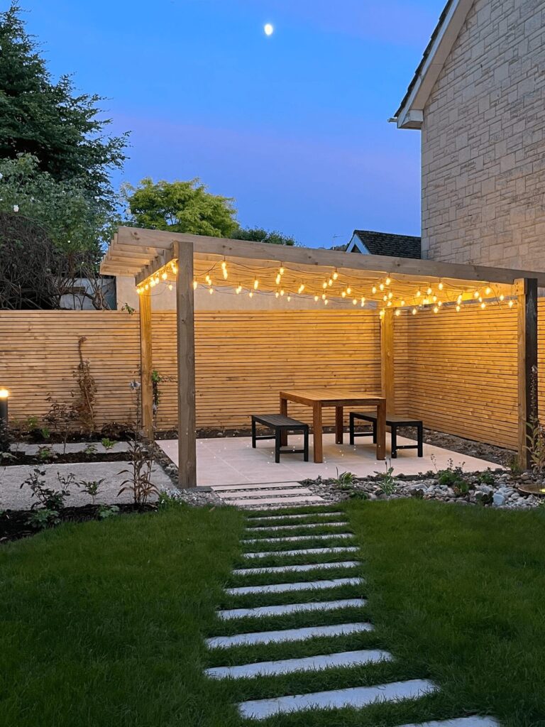 Kate Charles Garden Design - Courtyard Garden with twinkly lights and seating area