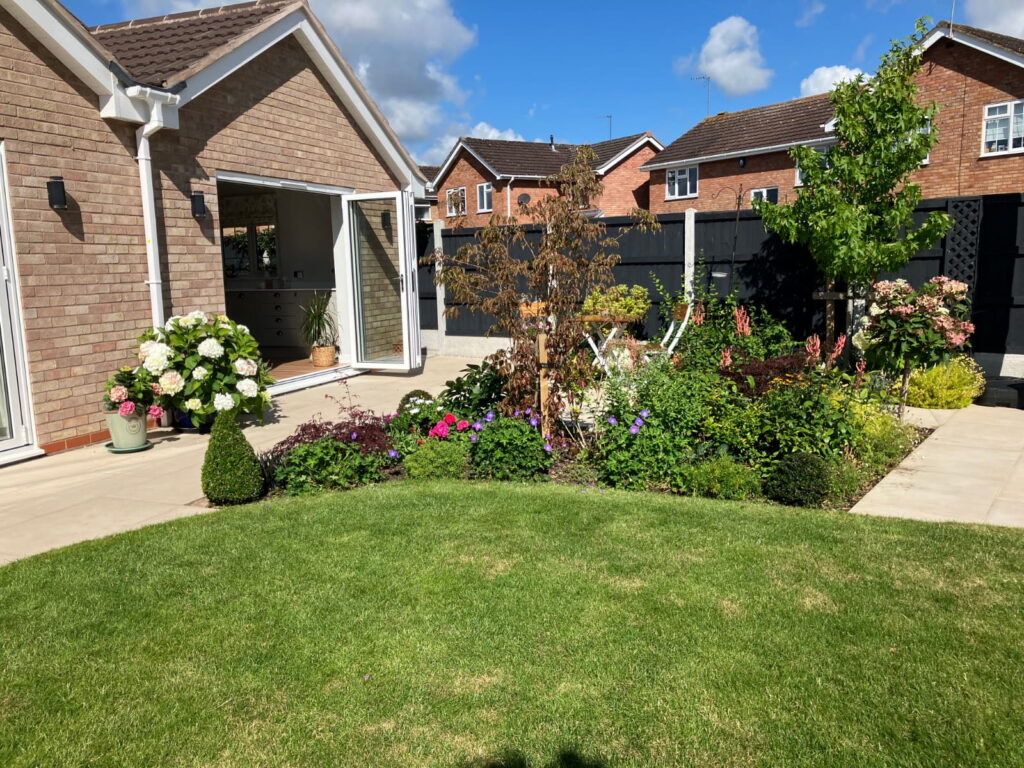 Kate Charles Garden Design - Renovation - Bifold Doors onto patio and lawn
