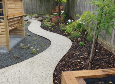 The winding path that follows the slope of the garden